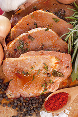 Image showing Pork tenderloin marinated with spices on a wooden board