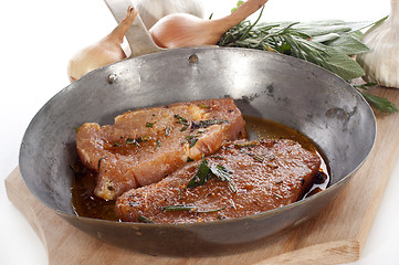 Image showing Pork tenderloin marinated with spices in a pan