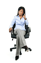 Image showing Businesswoman pointing sitting on office chair