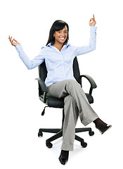 Image showing Happy businesswoman sitting on office chair