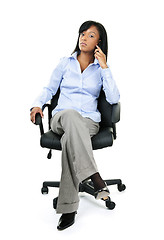 Image showing Businesswoman on phone sitting in office chair