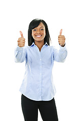 Image showing Smiling young woman giving thumbs up