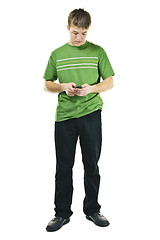 Image showing Young man texting on cell phone