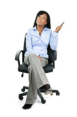 Image showing Thinking businesswoman sitting on office chair