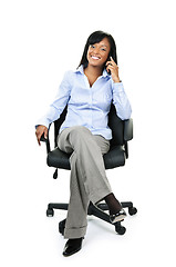 Image showing Businesswoman on phone sitting in office chair