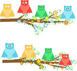 Image showing family owls sitting in tree branches with flower