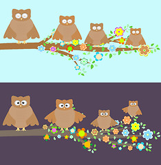 Image showing Family of owls sitting on a branch