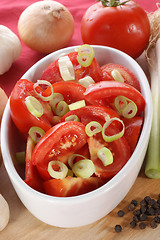 Image showing fresh tomato salad with spring onions in a bowl