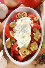 Image showing Tomato salad with herb yoghurt and olives in a bowl