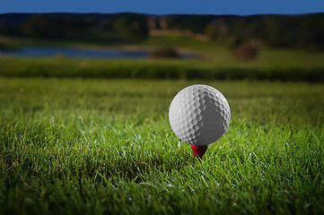 Image showing Golf ball on red tee 