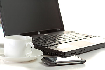 Image showing A cup of coffee and a pen on a laptop 