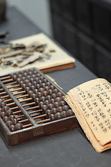 Image showing abacus and book on the table in a chinese old shop