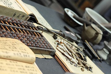 Image showing abacus and book on the table in a chinese old shop