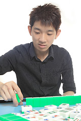 Image showing Chinese man play Mahjong, traditional China gamble. 