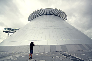 Image showing man takeing photo of modern building