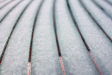 Image showing Snow thawing on car window