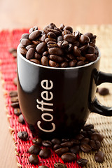 Image showing Coffee mug with coffee beans