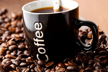 Image showing Coffee mug with coffee beans