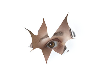 Image showing eye peeking through a hole
