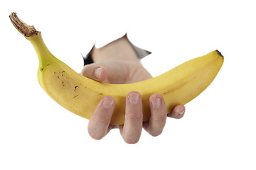 Image showing  hand from a hole is holding a banana