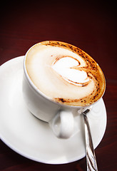 Image showing Coffee cup with milk and heart shape