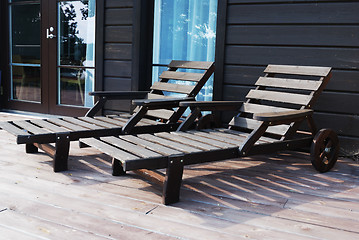 Image showing two wooden deck chairs on the terrace 