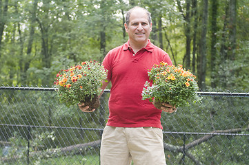 Image showing male homeowner gardening flowers outdoors