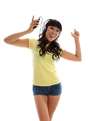 Image showing Vivacious girl listening to music and dancing