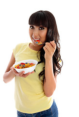 Image showing Smiling woman eating cereal breakfast