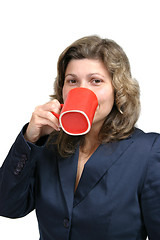 Image showing beautiful woman drinking a red mug of coffee
