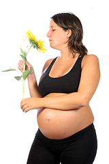 Image showing pregnant woman with beautiful belly and sunflower