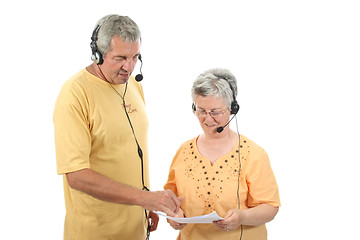 Image showing mature couple in a business call center