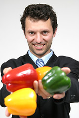 Image showing man holding color peppers, healthy food photo