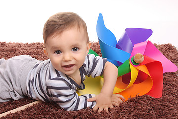Image showing beautiful and happy baby with wind mill