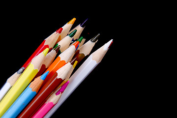 Image showing Assortment of coloured pencils with shadow on white/back backgro