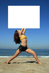 Image showing A gorgeous model holding a blank sign in the air