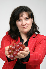 Image showing beautiful woman with red grapes, healthy food