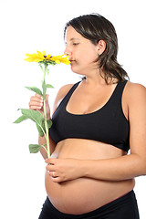 Image showing pregnant woman with beautiful belly and sunflower