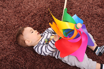 Image showing beautiful and happy baby with wind mill