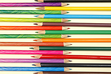 Image showing Assortment of coloured pencils with shadow on white background