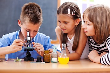 Image showing Boy looking into microscope