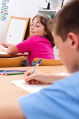 Image showing Schoolgirl looking at colleague's test