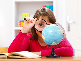 Image showing Schoolgirl with loupe