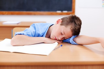 Image showing Boy sleeping in classroom