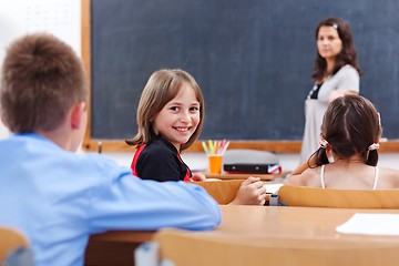 Image showing Cheerful schoolgirl in class room