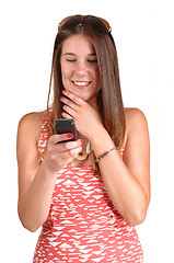 Image showing Girl looking at phone.