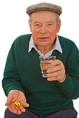 Image showing Male senior taking medicine
