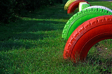 Image showing Painted wheels from rubber fixed at playground