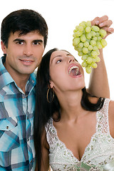 Image showing Couple playfully eating grapes