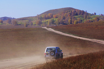 Image showing Off-road vehicle running in the grassland